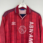 1994 Ajax training shirt by Umbro in excellent condition, featuring red design and ABN AMRO logo, size XL.