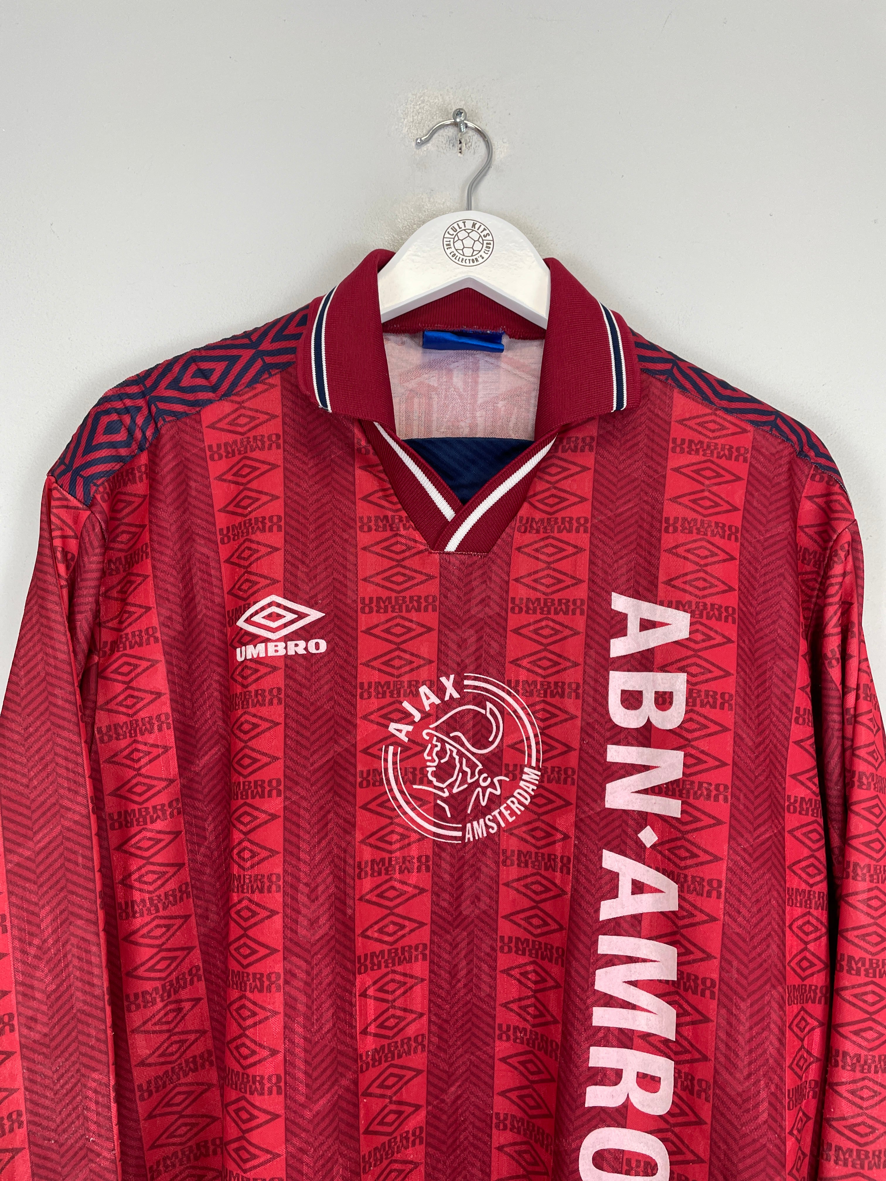 1994 Ajax training shirt by Umbro in excellent condition, featuring red design and ABN AMRO logo, size XL.