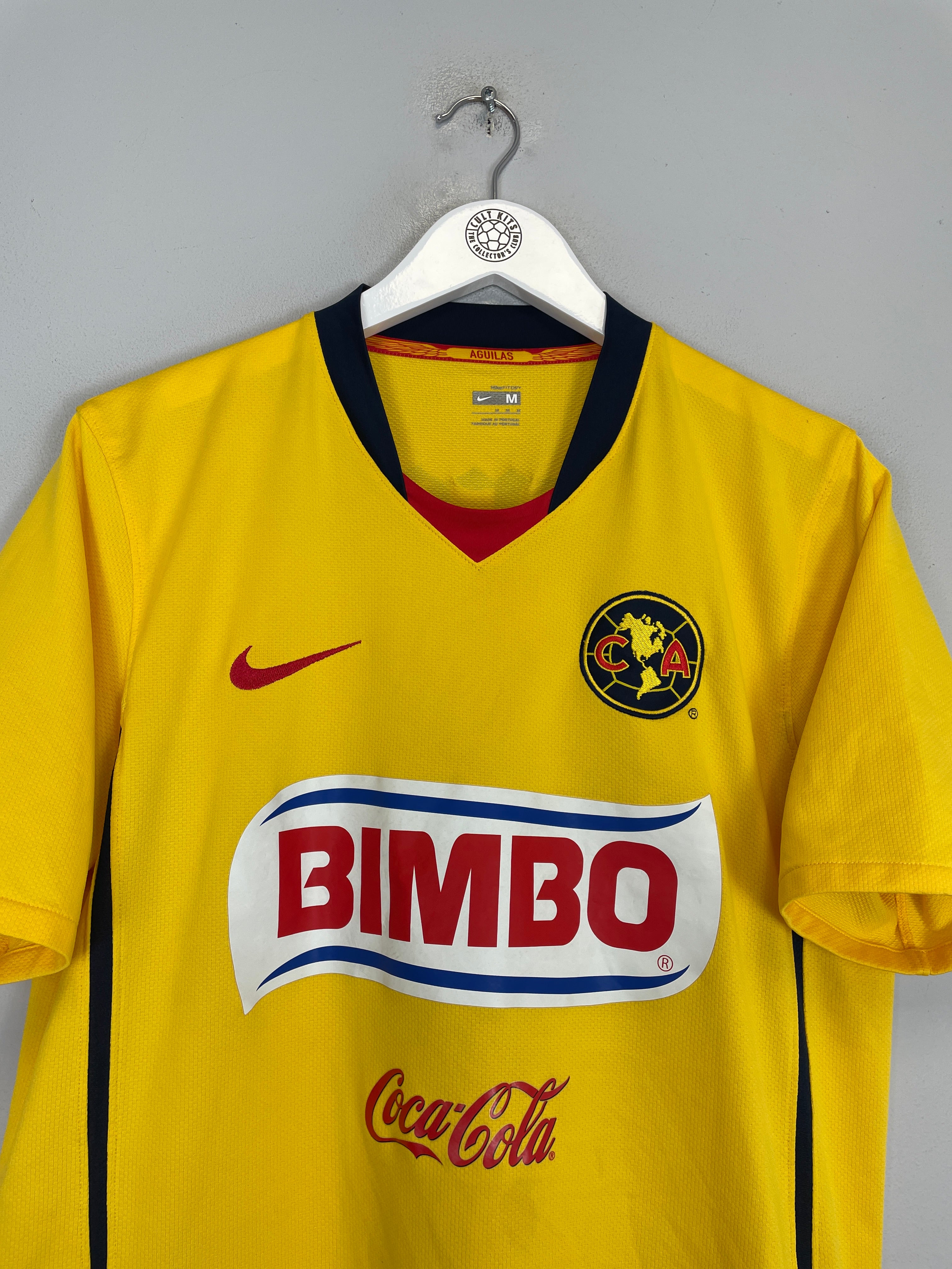 2008/09 Club America home shirt by Nike in medium size, yellow with logo and sponsor, showing excellent condition.