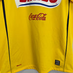 2008/09 Club America home shirt by Nike, yellow with Bimbo and Coca-Cola logos, size medium, good condition.