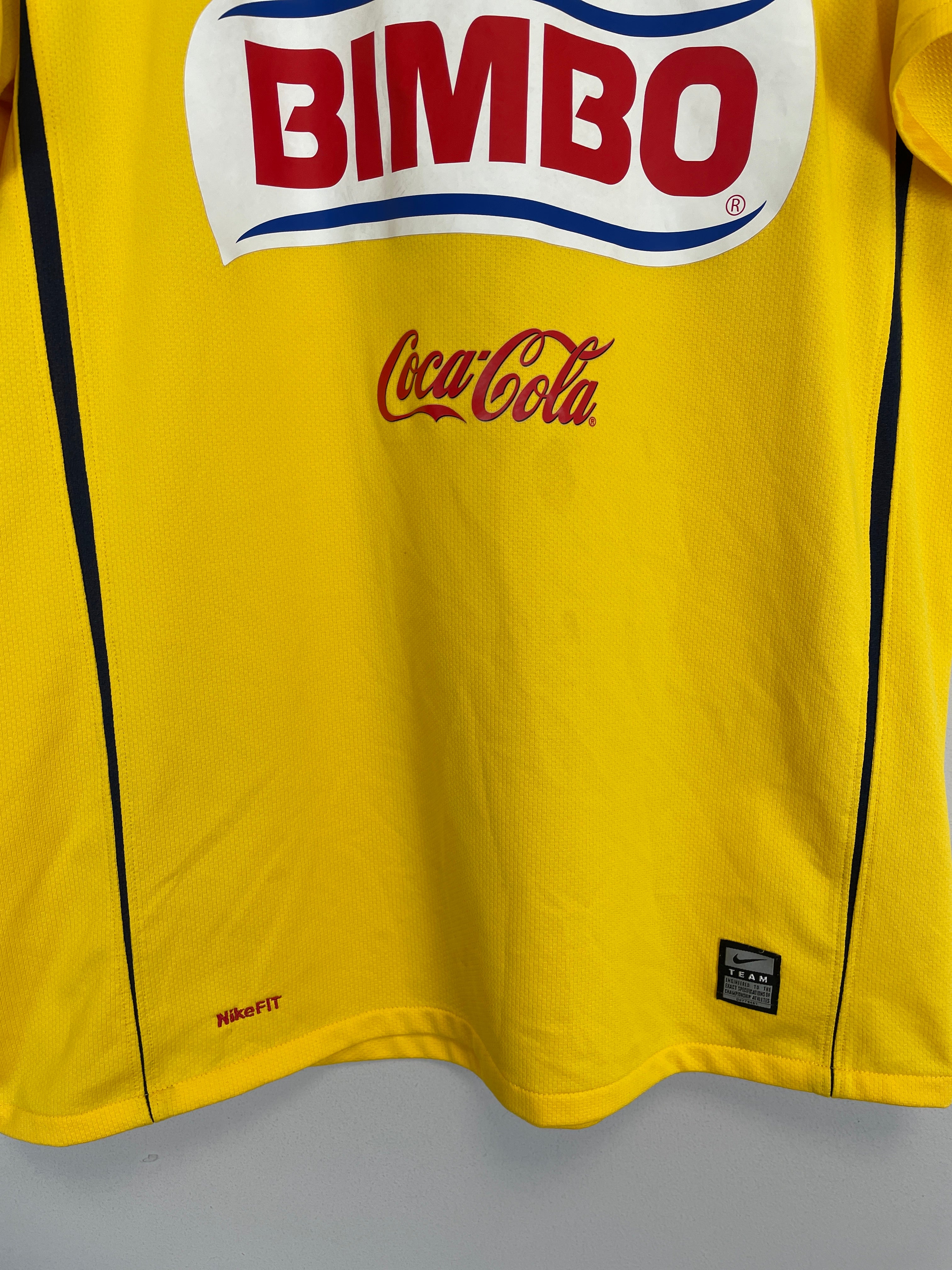 2008/09 Club America home shirt by Nike, yellow with Bimbo and Coca-Cola logos, size medium, good condition.