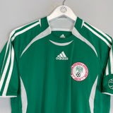 2006/07 Nigeria home shirt by Adidas, size small, in excellent condition, featuring green color and team logo.