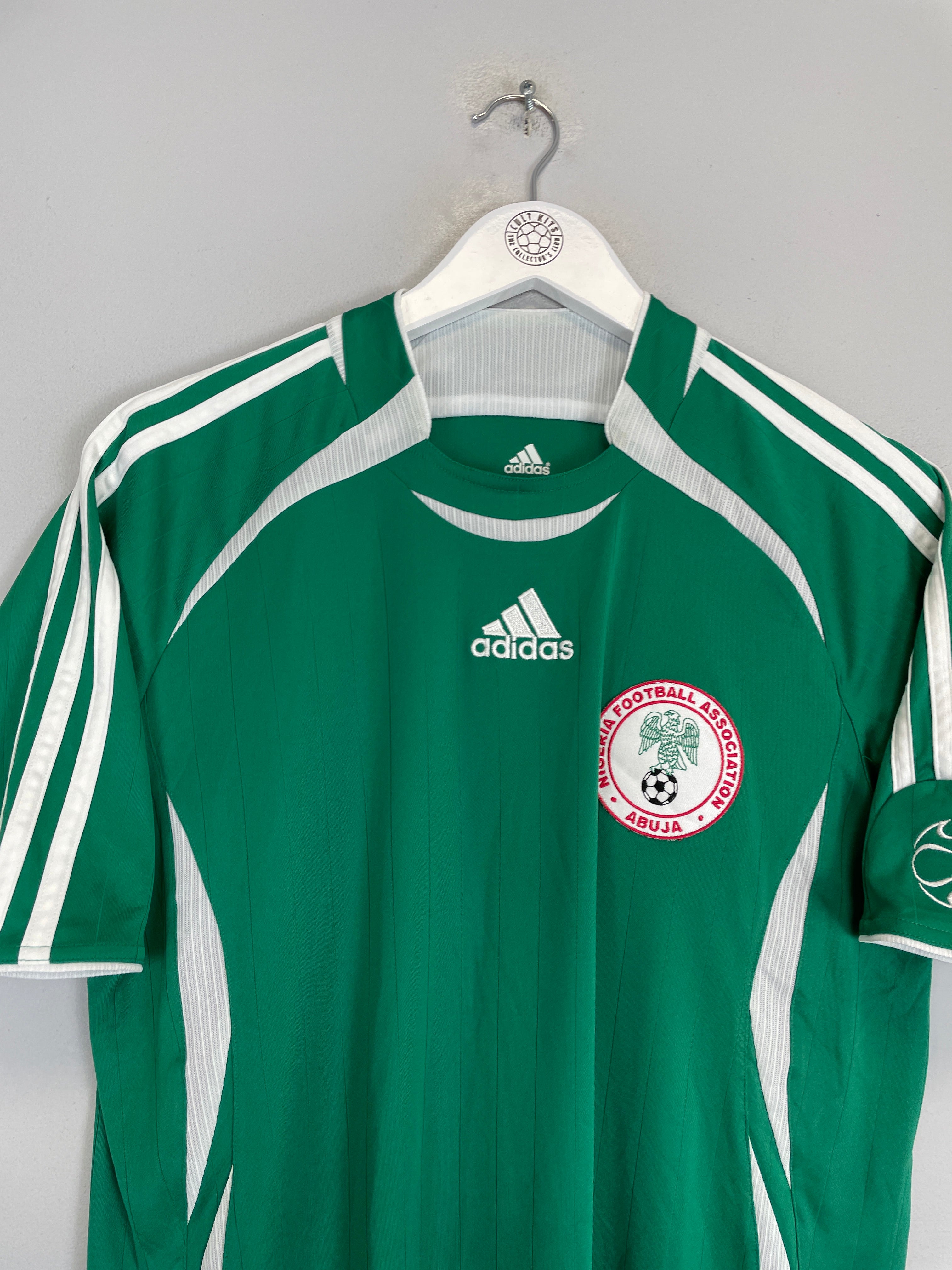 2006/07 Nigeria home shirt by Adidas, size small, in excellent condition, featuring green color and team logo.