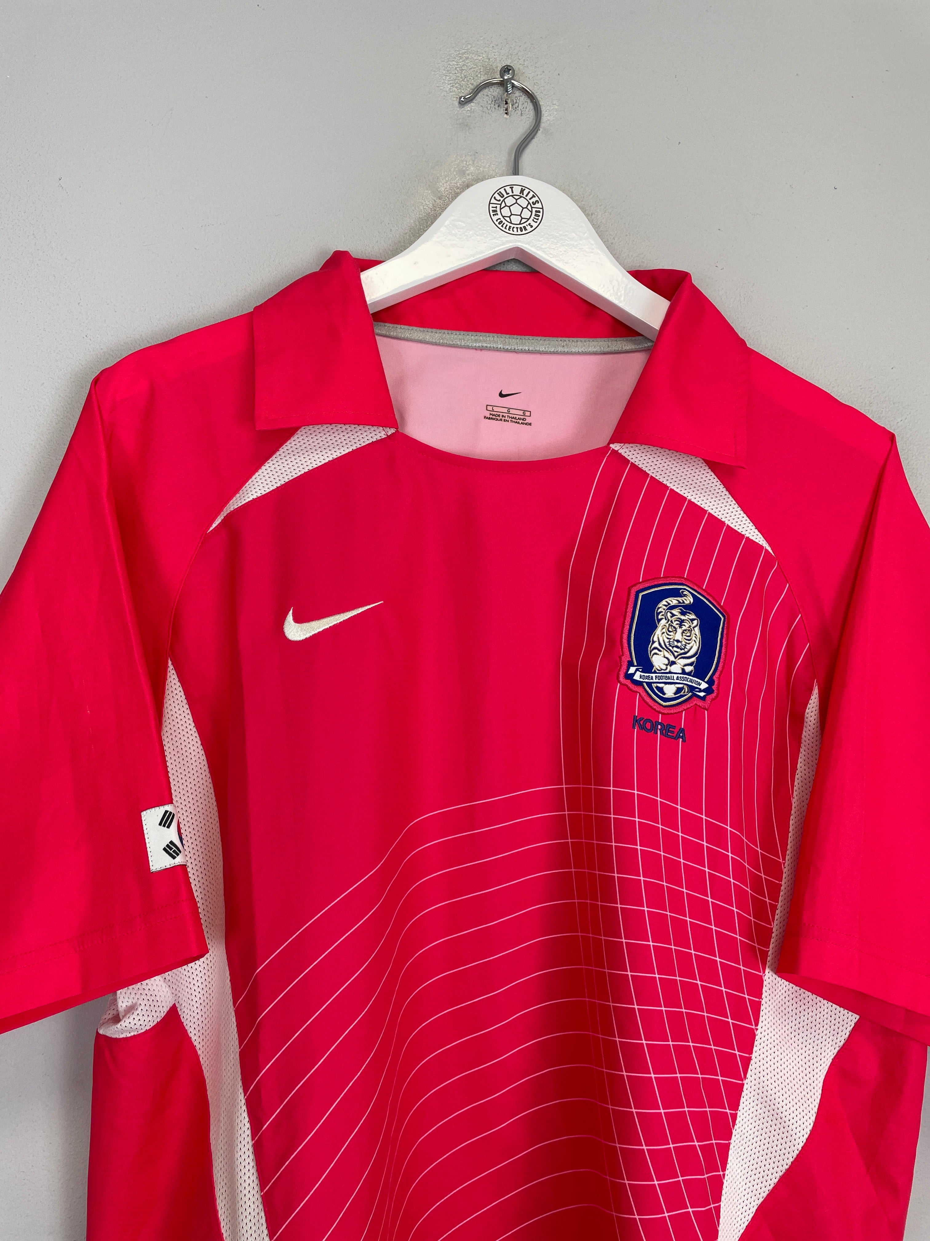 2002/04 South Korea home shirt size L by Nike in excellent condition, vibrant pink with logo and mesh design.