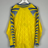 Back view of a vibrant yellow 1995/97 Parma L/S home shirt by Puma, featuring blue accents and a diamond pattern.