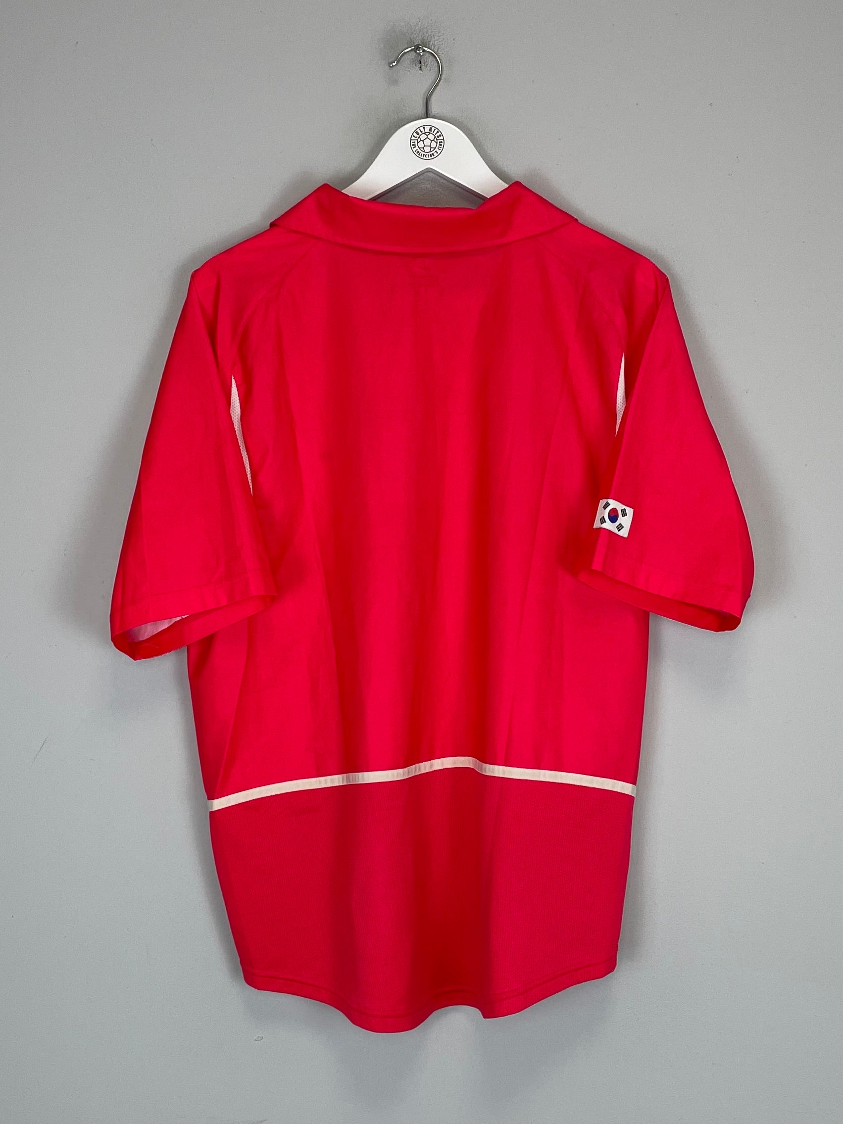 Back view of a 2002/04 South Korea home shirt (L) by Nike in excellent condition, featuring team logo and vibrant red color.